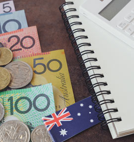 Australian coins, notes, a flag and a notebook.